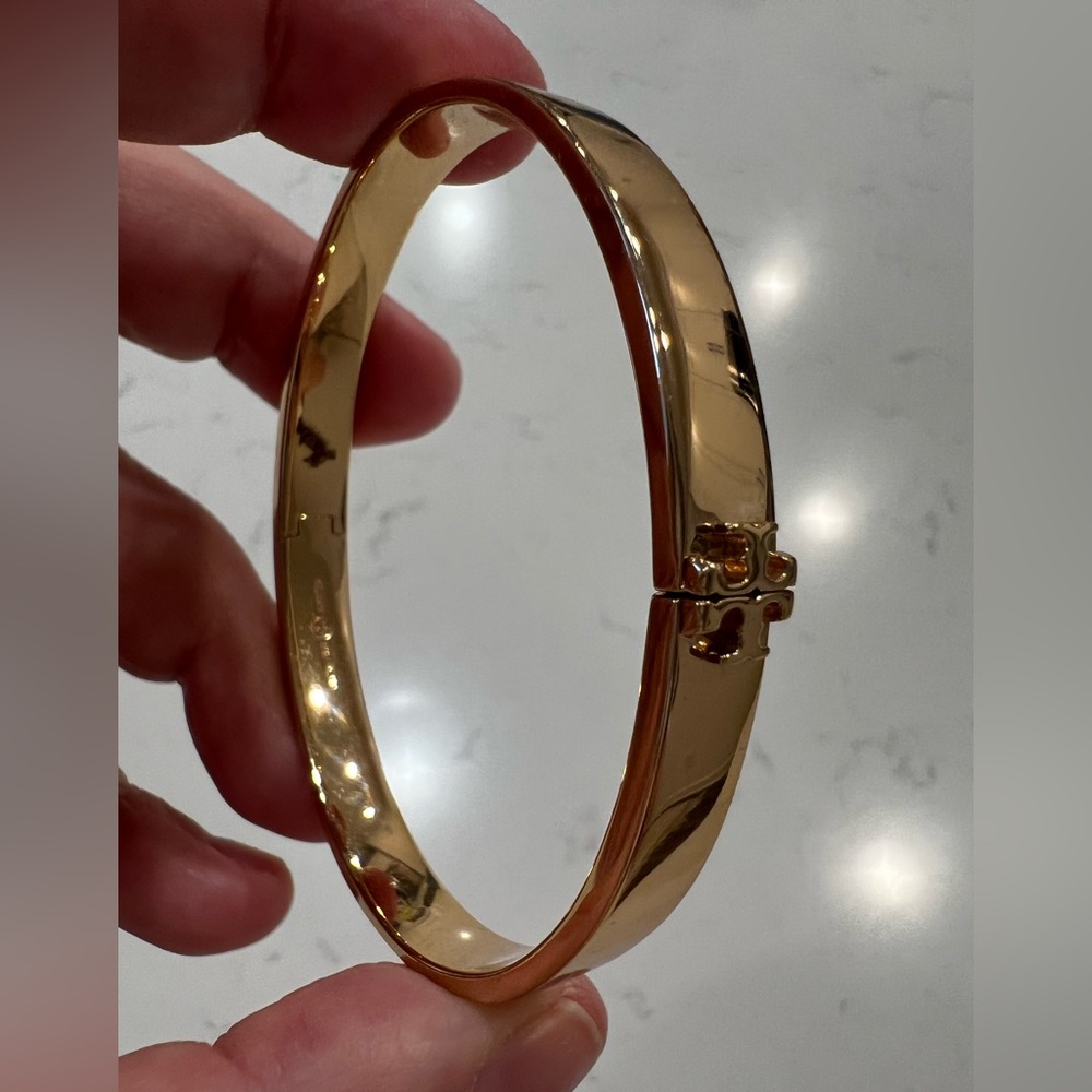 Gold Tory Burch snap bracelet.
